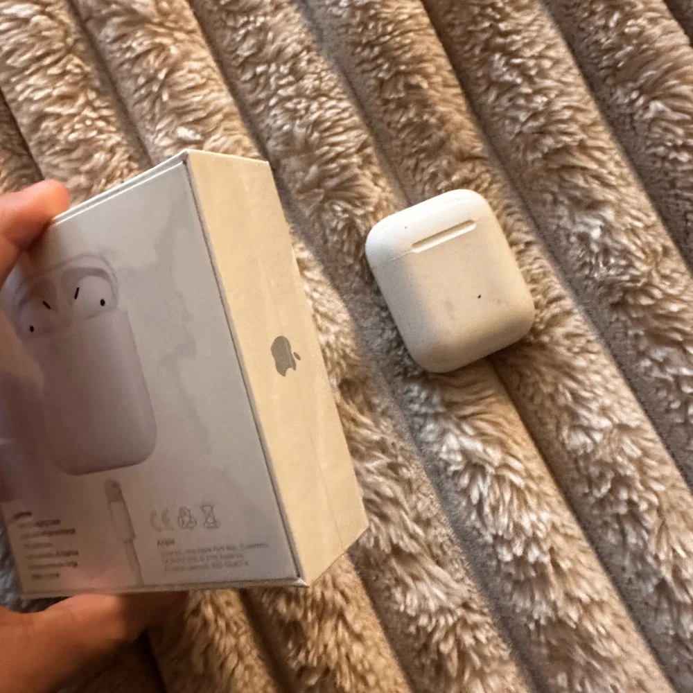 (1) brand new AirPods (1) second hand AirPods total of 2